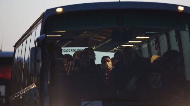 Migrants arrive on a bus at the port of Mytilene in the Greek island of Lesbos, on Monday.