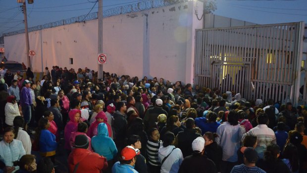 Concerned relatives of inmates stand outside the Topo Chico prison, where a riot broke out around midnight, in Monterrey, Mexico.