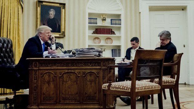 Mr Trump's national security adviser Michael Flynn, centre, and chief strategist Steve Bannon listen in on the President's phone call with Mr Turnbull.