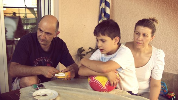 Minos Prinarakis, his wife Natassa Limou and their son Manos at home in Larissa, Greece, in 2015. They've been dealing with Greece's financial crisis for four years.
