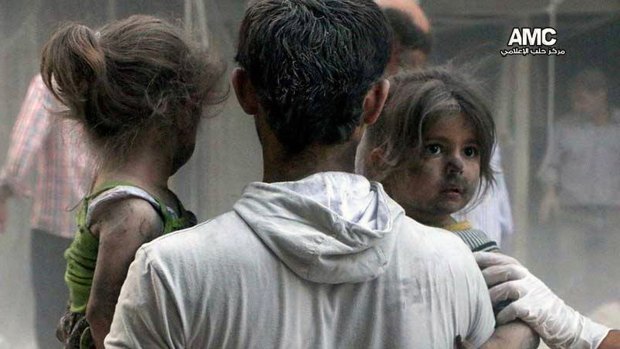 This image from a rebel media service shows Syrian children being rescued from a building hit by a regime air strike in the Shaar district of Aleppo in July.