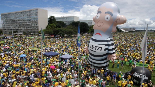Thousands of demonstrators demand President Dilma Rousseff's impeachment in Brasilia on Sunday where a large inflatable doll depicts former president Luiz Inacio Lula da Silva in prison garb.