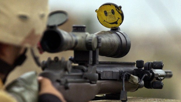 A happy face smiles back from the scope of a US Army sniper's rifle in Iraq. The US is the world's top weapons supplier.