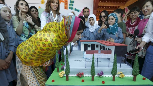 Malala Yousafzai blows out candles on her birthday cake at a school for Syrian refugee girls, built by the NGO Kayany Foundation, in Lebanon's Bekaa Valley.