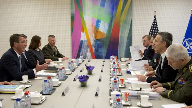 US Secretary of Defence Ash Carter, left, speaks with NATO Secretary-General Jens Stoltenberg, second right, during the meeting on Wednesday.