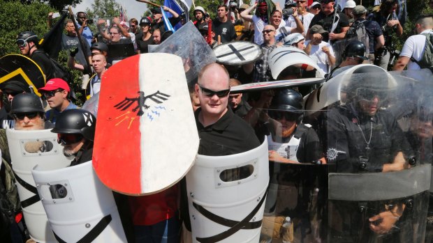 White nationalist demonstrators use shields as they guard the entrance to Emancipation Park in Charlottesville on August 12, 2017.