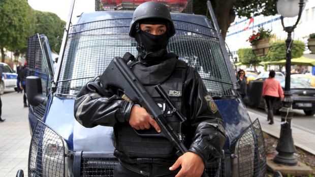 A Tunisian policeman stands guard at Bourguiba Avenue in the capital of Tunis.