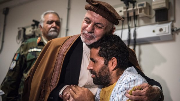Afghan President Ashraf Ghani embraces Abdul Jalil, who was injured during fighting, at Dawood National Military Hospital in Kabul.