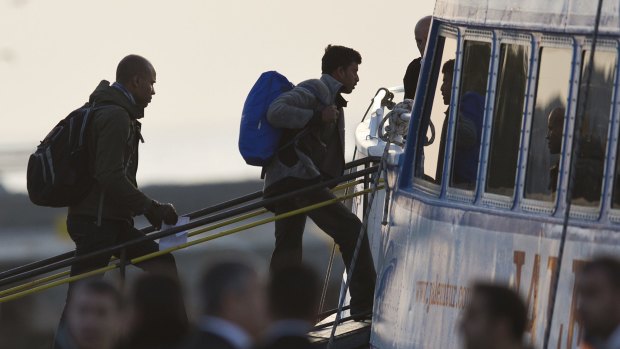 Migrants board a ferry in the Greek island of Lesbos on Monday. 