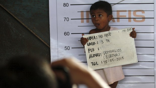 A Rohingya child who recently arrived by boat has his picture taken for identification purposes at a shelter in Kuala Langsa.