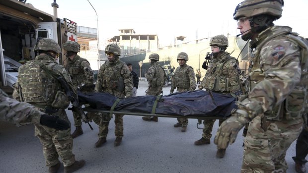 British soldiers carry the body of a victim of an attack that happened near Spanish embassy in Kabul, Afghanistan, last month.