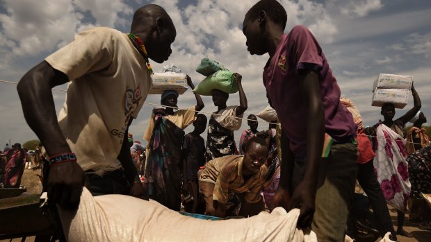 Refugees collect food in South Sudan, where famine was declared earlier this year.