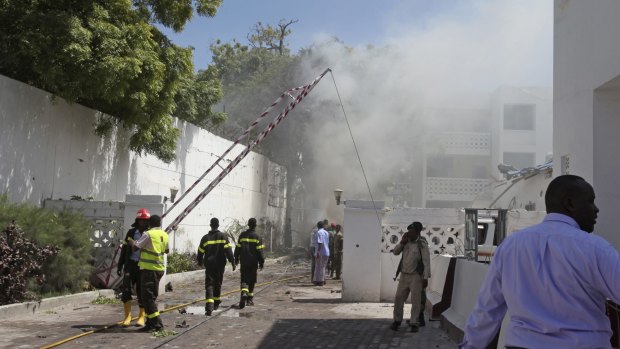Smoke and steam clouds the scene of a twin bombing attack on the Central Hotel in Mogadishu, Somalia. 