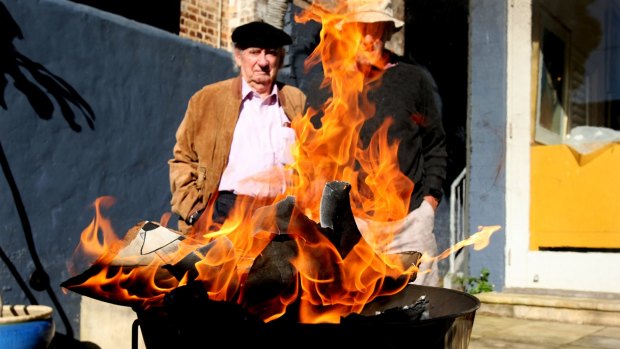 Renowned artists Charles Blackman and Robert Dickerson stand outside the Dickerson Gallery in Woollahra in 2010 watching the court-ordered destruction of fake paintings.