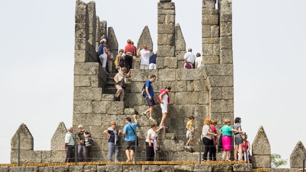 Tourists visit the medieval Castle of Guimaraes.