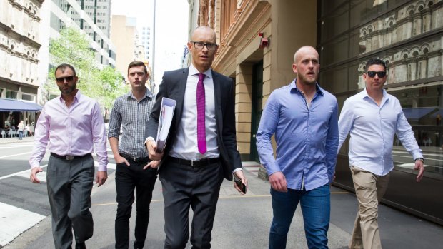 Shane Housego, Christian McDonald, Chris Sheehy and Steven Rapisarda join lawyer Nicholas Stewart (centre) to lodge papers at the NSW Civil and Administrative Tribunal in Sydney. 