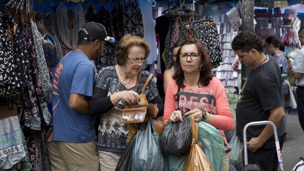 People shop in Sao Paulo, Brazil. Latin America's largest economy has shrunk even more than expected, increasing fears about the well-being of a nation hammered by falling commodity prices and a massive corruption scandal.