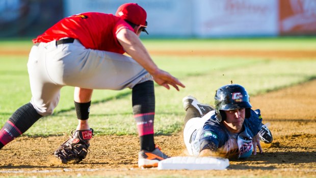 Cavalry's Scott Kelly slides into first base.