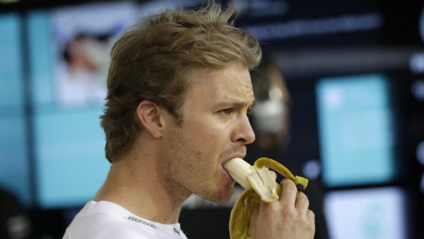 Nico Rosberg eats a banana in the pit.