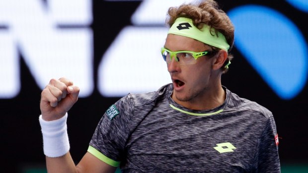 Uzbekistan's Denis Istomin reacts after winning the fourth set tie-breaker.