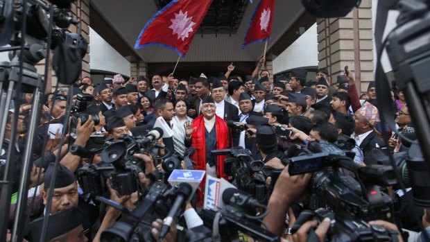 Nepal's newly-appointed prime minister Khadga Prasad Oli surrounded by journalists at the Constituent Assembly in Kathmandu on Sunday. 
