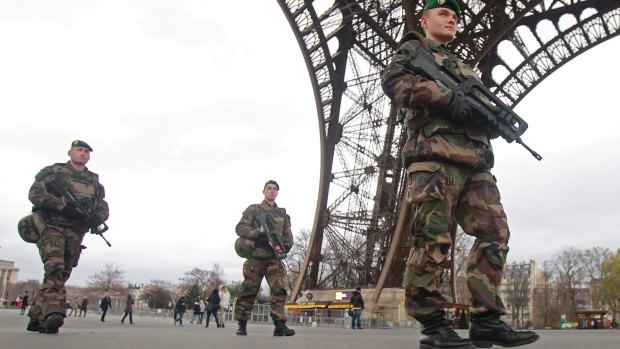 French army soldiers patrol under the Eiffel Tower in Paris in January.