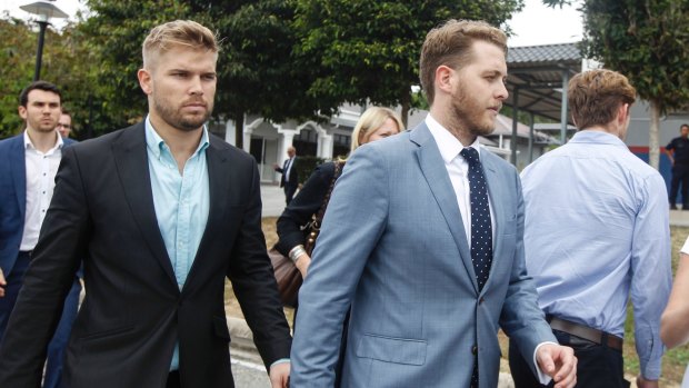 Edward Leaney and Jack Walker leave court in Sepang, Malaysia.