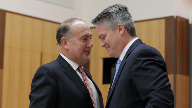 Treasury chief John Fraser (left) and Finance Minister Mathias Cormann (right) expressed a different view on the report's ownership than did Treasurer Joe Hockey.