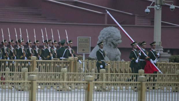 Chinese paramilitary police march to a flag raising ceremony on Tiananmen Square outside the Great Hall of the People on Saturday. 