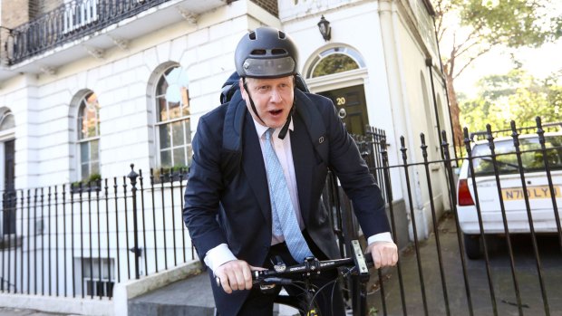 Boris Johnson, former mayor of London, rides a bicycle as he leaves his home in London on Tuesday. 