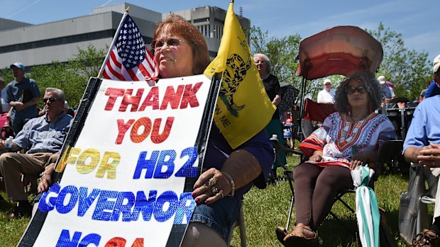 Lee Churchill shows her support of the bill during a rally at the Halifax Mall in Raleigh on Monday.