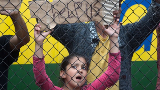 Migrants protest outside a train in Bicske they are refusing to leave for fear they will be taken to a refugee camp.