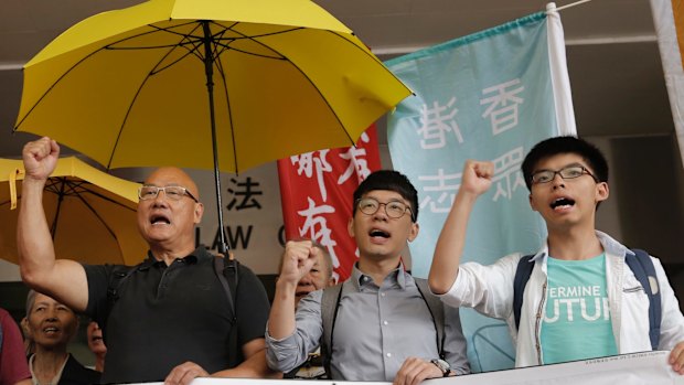 From left, lawmaker Albert Chan and pro-democracy leaders Nathan Law and Joshua Wong last year after Wong was acquitted of obstructing police at a 2014 protest.