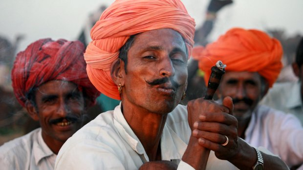 Rajasthani camel drivers smoking chillum.