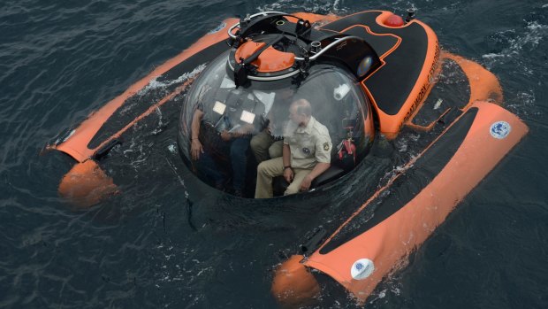 Russian President Vladimir Putin sits on board a bathyscaphe as it plunges into the Black Sea.