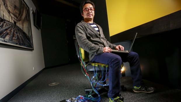 Dr Stephen Jia Wang testing a prototype of his smart chair designed to "get to know you and your sitting behaviour".
