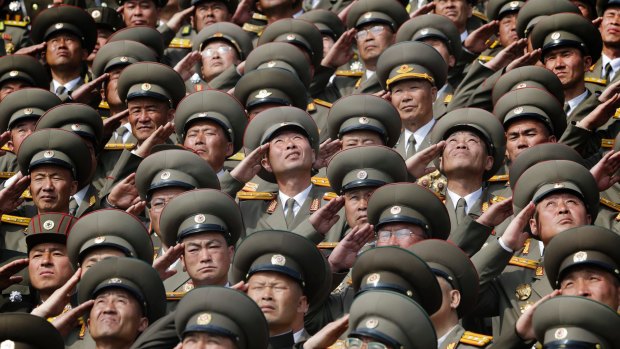 North Korean soldiers salute as their national anthem is played during a military parade to celebrate the 105th birth anniversary of Kim Il-sung.