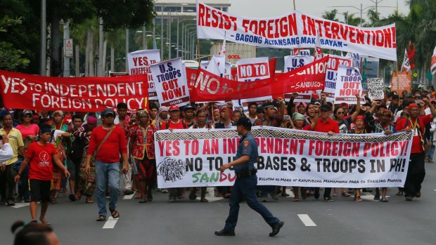 Protesters reject US troops in the Philippines in Manila on Wednesday. But how will the wider population of the Philippines greet the president's new direction?