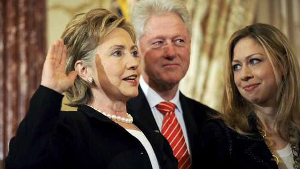 Hillary Clinton is joined by her husband former US President Bill Clinton and daughter Chelsea Clinton as she is ceremonially sworn in at the State Department in Washington in 2009. 