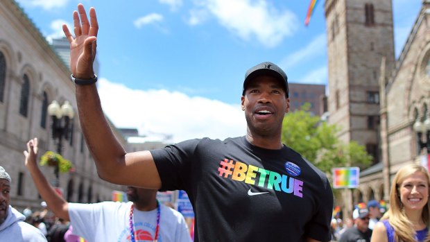Pioneer: Former Boston Celtics centre Jason Collins waves to the crowds at the annual Boston Pride Parade in 2013.