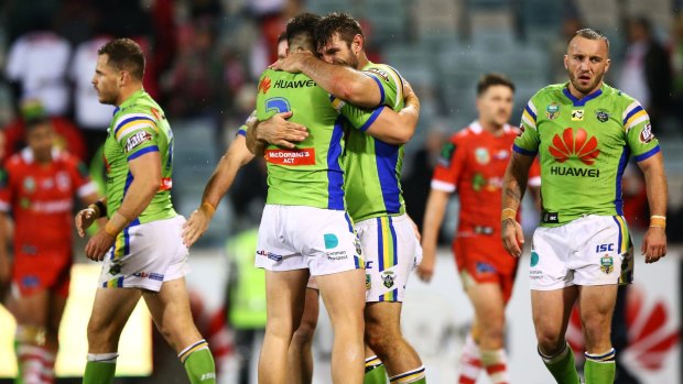 Nikola Cotric and David Taylor, of the Raiders, celebrate their victory over the St George Illawarra Dragons.