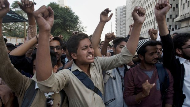 Members of the student wing of Pakistani religious group Jamaat-e-Islami chant slogans during a demonstration to condemn the attack.