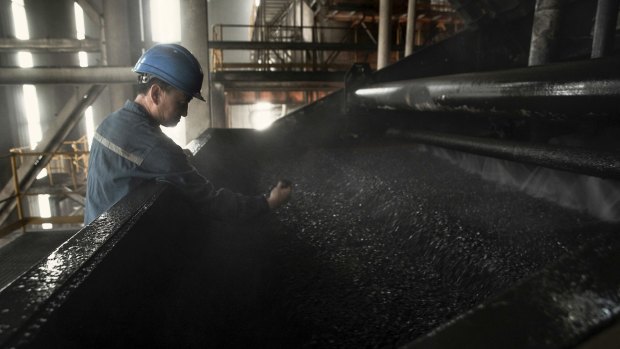 A worker monitors the coal washing process at a mine in Datong, China, in May 2014. 