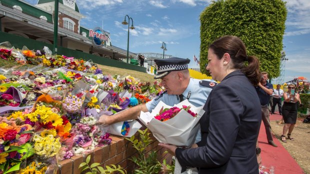 Queensland Premier Annastacia Palaszczuk and police assistant commissioner Brian Codd pay their respects at Dreamworld.