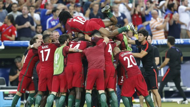 Portugal players celebrate after Eder scores the winner.