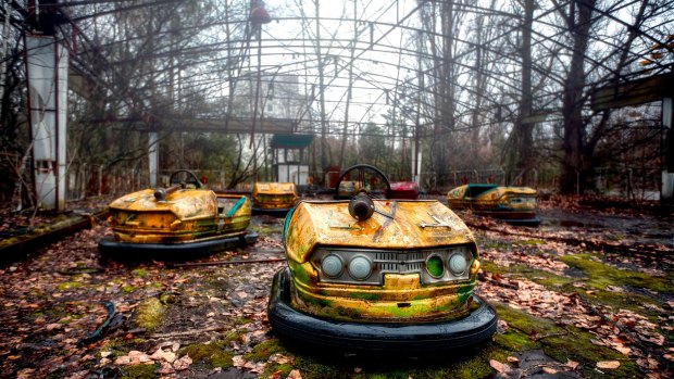 An abandoned collection of dodgem cars sprouting weeds in Chernobyl.