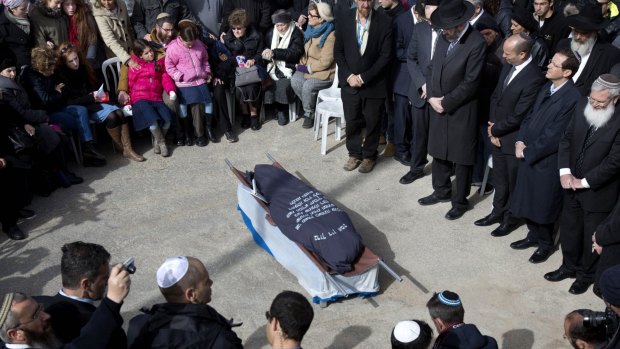 Family and friends of Israeli Dafna Meir attend her funeral at a cemetery in Jerusalem on Monday. A Palestinian attacker stabbed and wounded a pregnant Israeli woman in the West Bank before being shot, Israeli officials said. 
