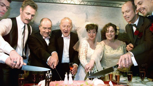 From left: Peter Lemke, Frank Wittebrood, Ton Jansen, Louis Rogmans, Helene Faasen, Anne-Marie Thus, Dolf Pasker and Geert Kasteel cut the cake after their wedding ceremony in the town hall of Amsterdam on April 1, 2001. The two lesbian brides and six gay grooms became the world's first homosexuals to wed legally, minutes after a Dutch law allowing same-sex matrimony came into effect.  
