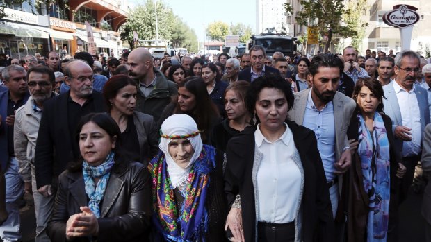 Politicians from the pro-Kurdish Peoples's Democratic Party (HDP) march as they protest against the detention of  Diyarbakir's mayors, Gultan Kisanak and Firat Anli, in October. Turkish police used tear gas and water cannons to disperse the demonstration.