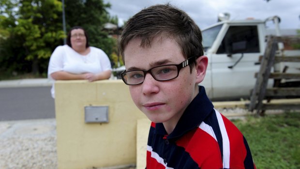 Danielle McMahon, of Ngunnawal, at  home with her 13-year-old
autistic son, Jay. 